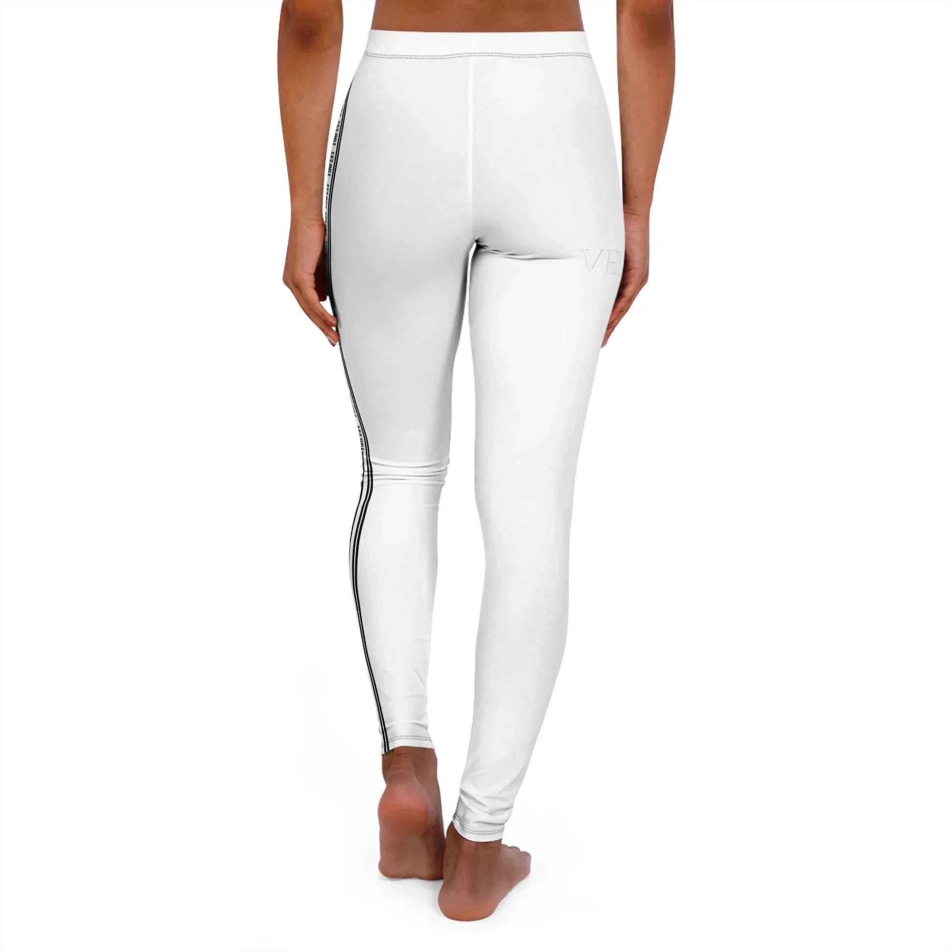 Woman wearing white high-waist leggings with black side stripes standing barefoot