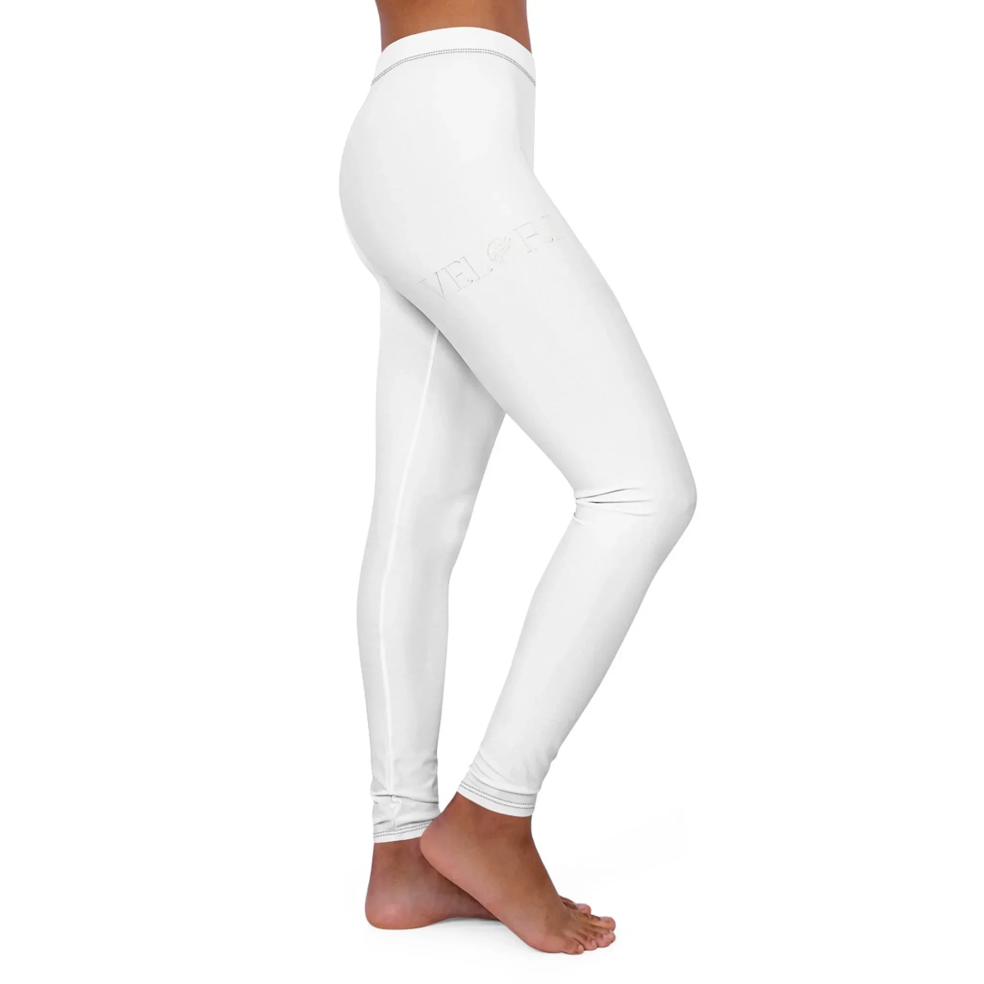 Side view of person wearing white high-waisted leggings with subtle logo detail, barefoot
